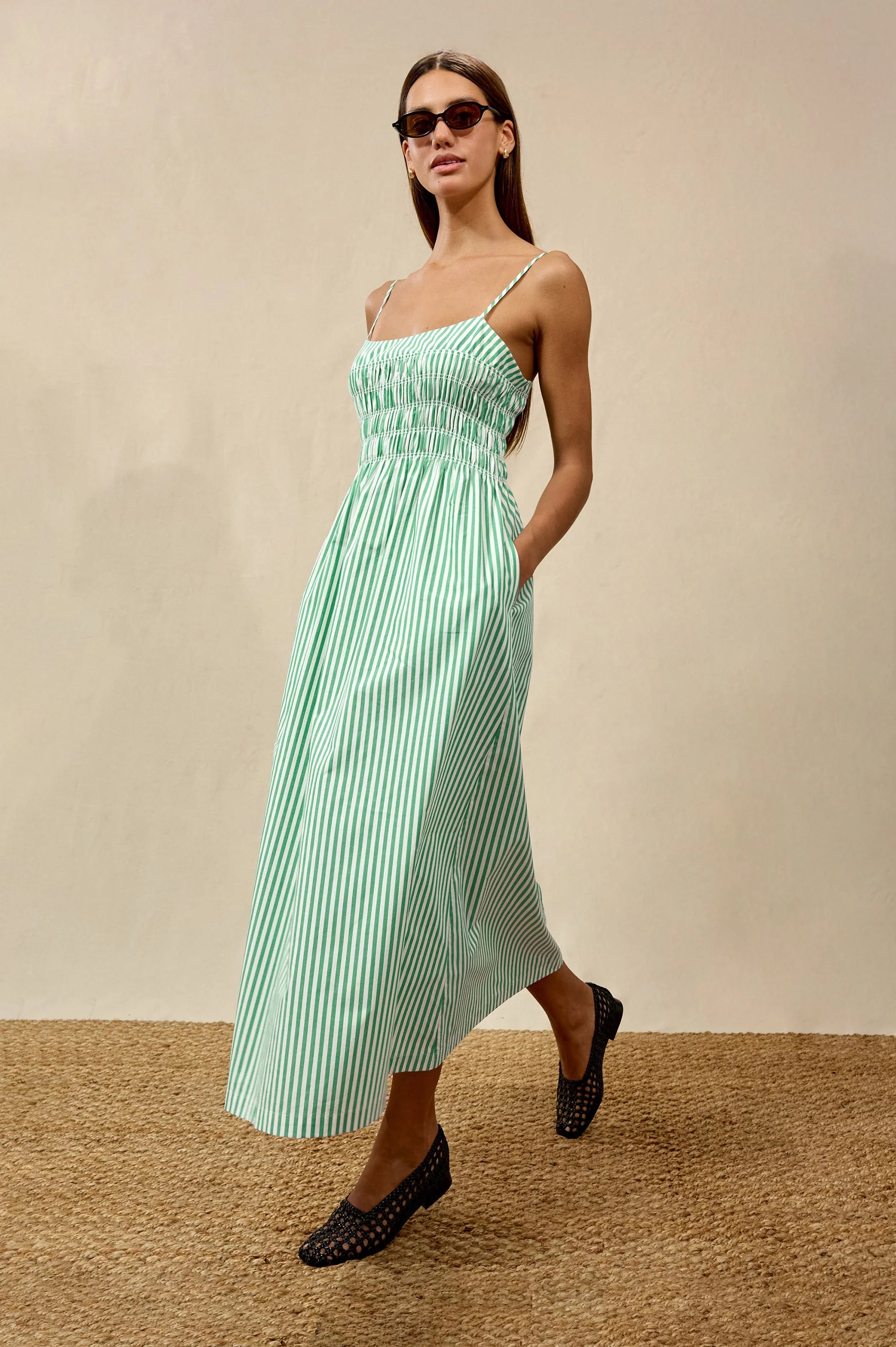 Woman wearing white and green stripe dress from rails