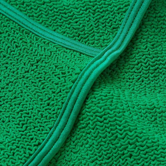 dark green thin strap scoop neck crinkle swimsuit from hunza g close up of fabric