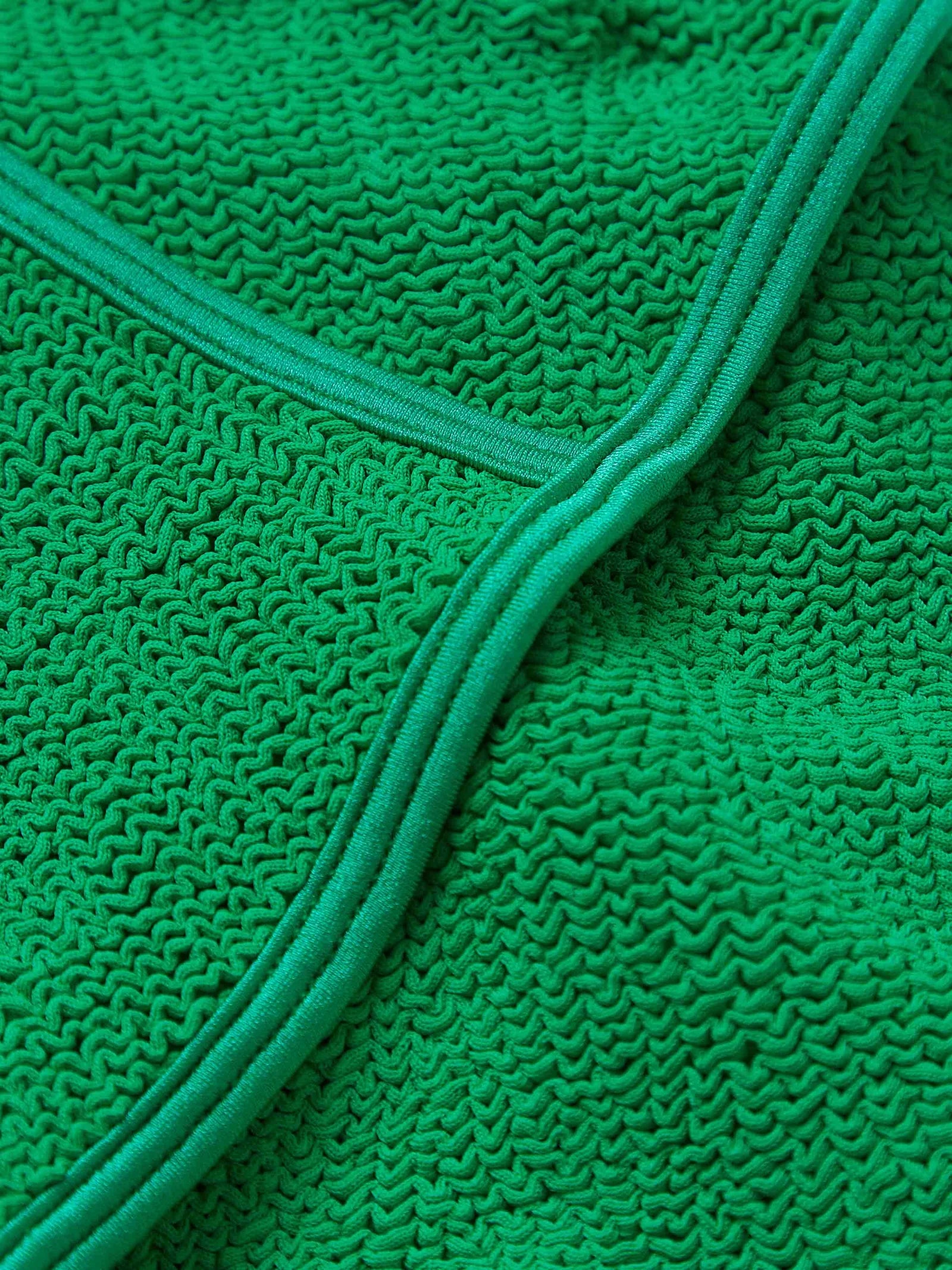 dark green thin strap scoop neck crinkle swimsuit from hunza g close up of fabric
