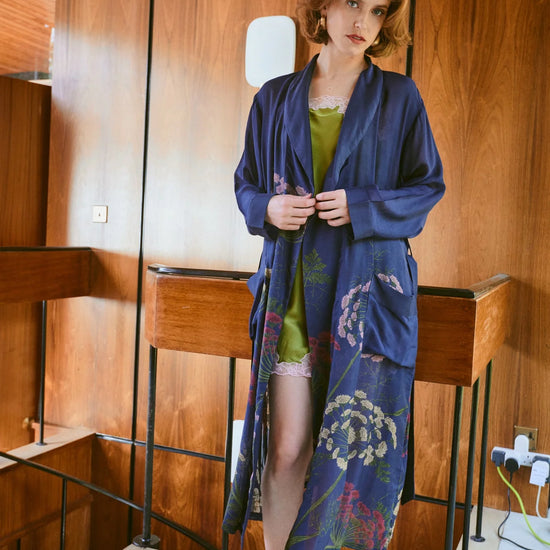 navy dressing gown with vibrant parsley seed flowers all over from one hundred stars model shot