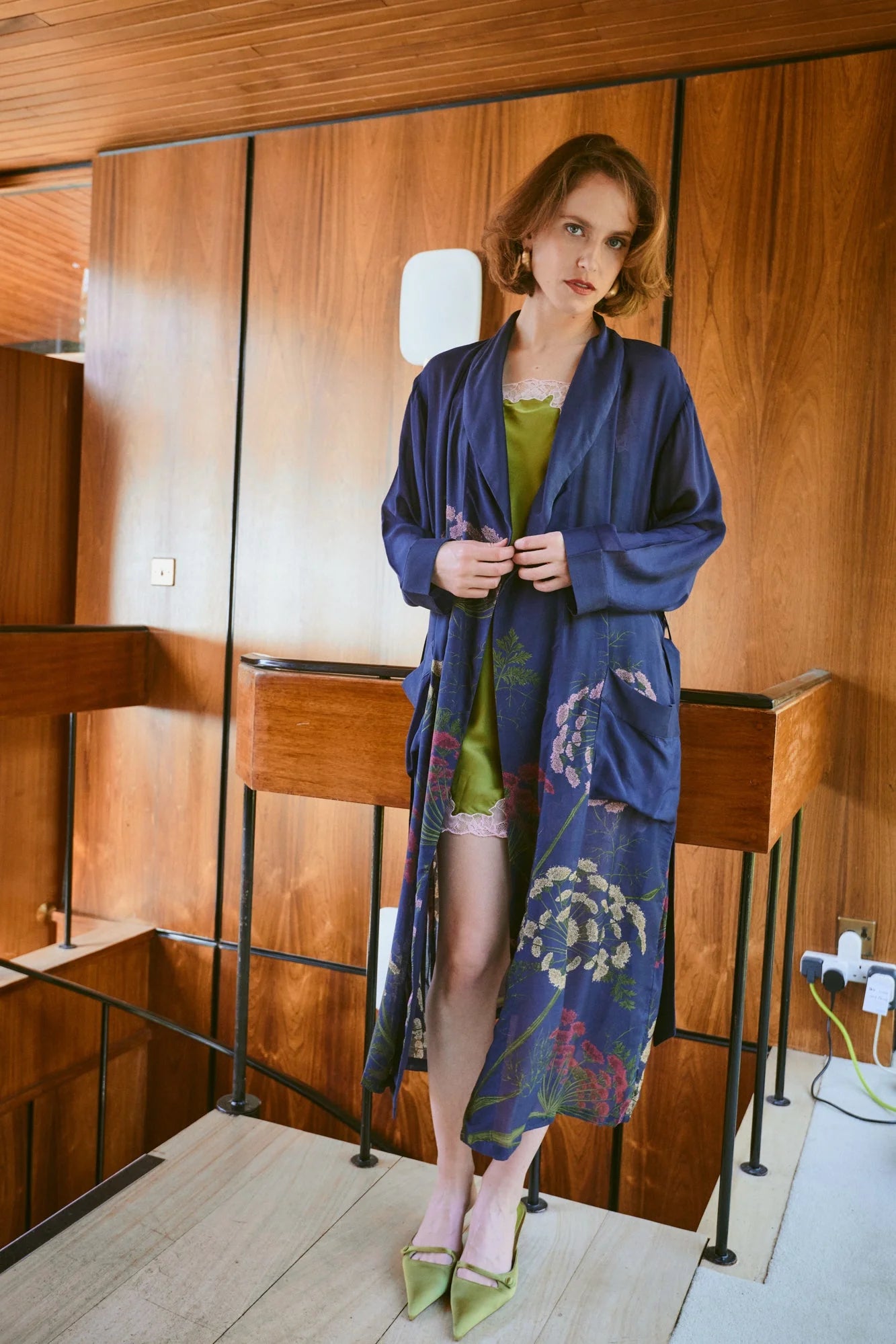 navy dressing gown with vibrant parsley seed flowers all over from one hundred stars model shot