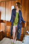 navy dressing gown with vibrant parsley seed flowers all over from one hundred stars model shot
