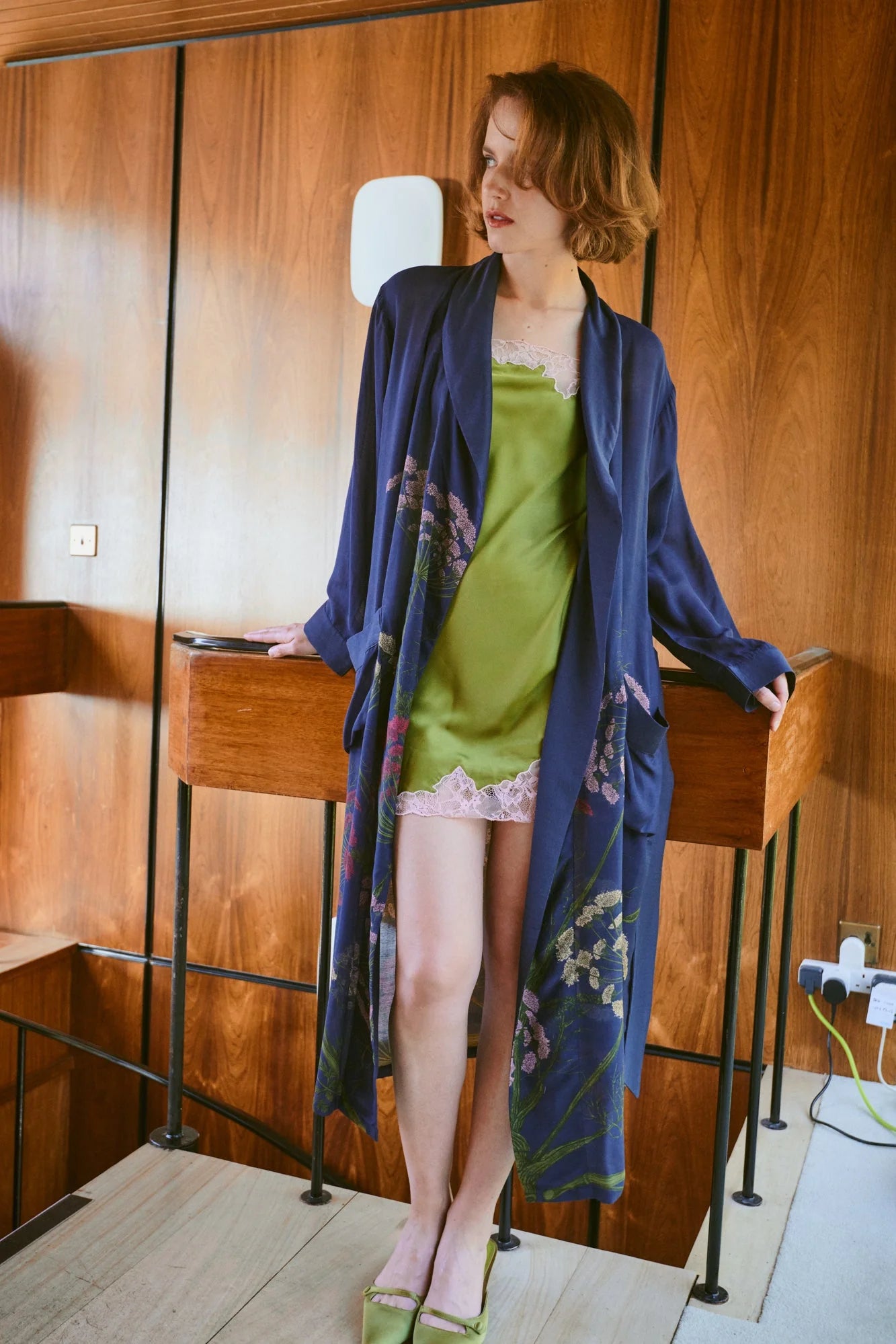 navy dressing gown with vibrant parsley seed flowers all over from one hundred stars model shot