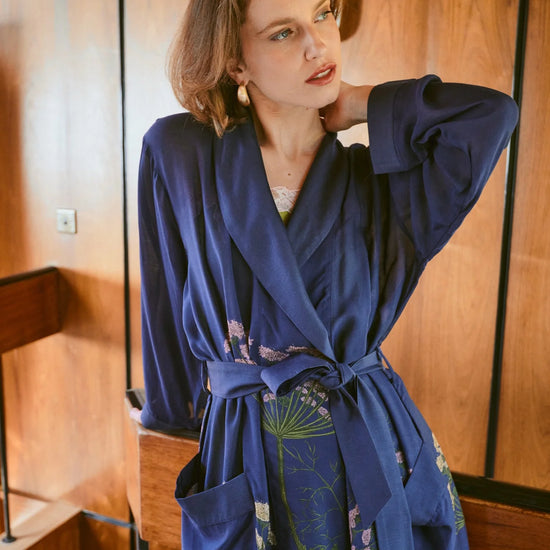 navy dressing gown with vibrant parsley seed flowers all over from one hundred stars model shot
