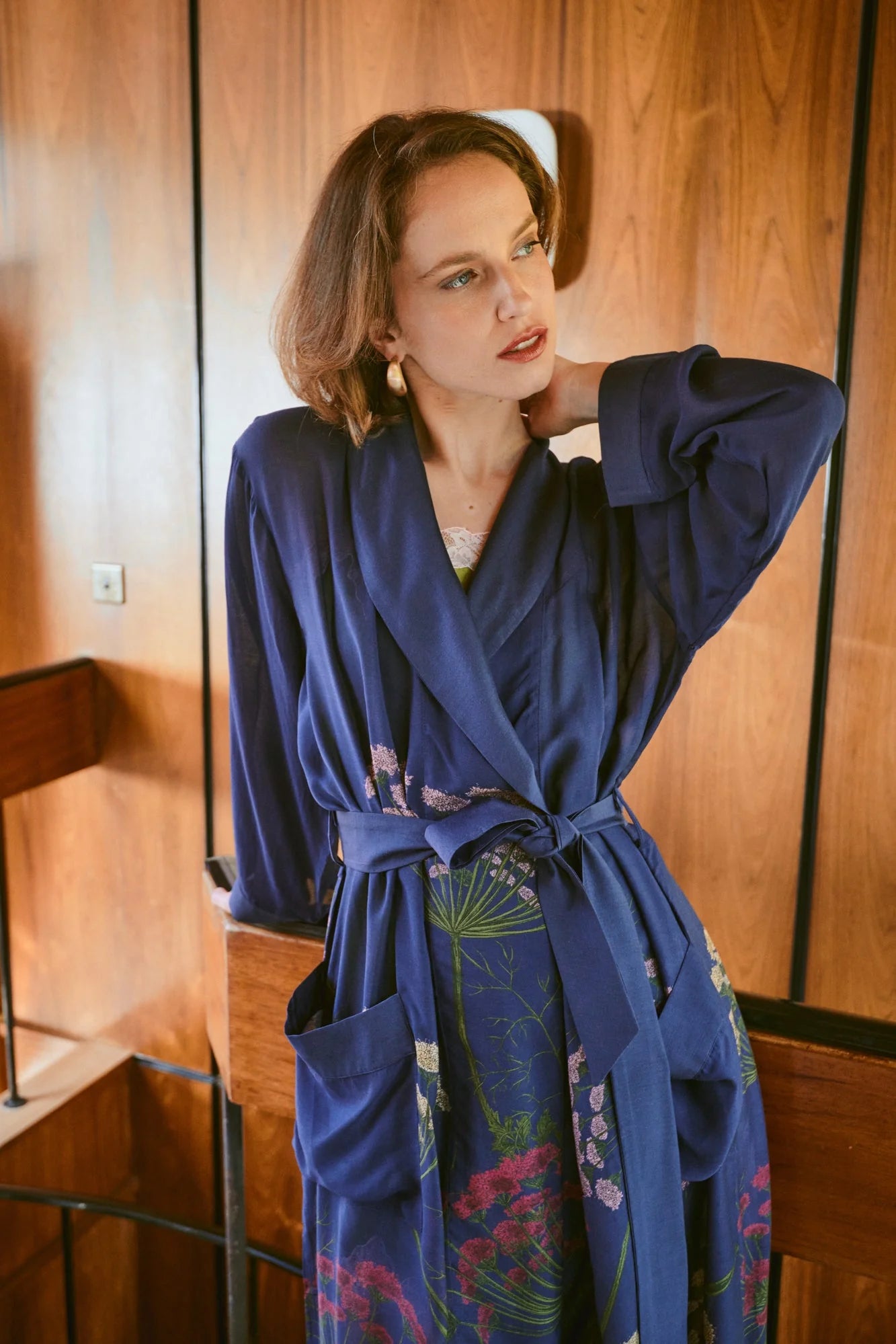 navy dressing gown with vibrant parsley seed flowers all over from one hundred stars model shot