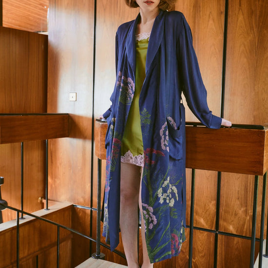 navy dressing gown with vibrant parsley seed flowers all over from one hundred stars model shot