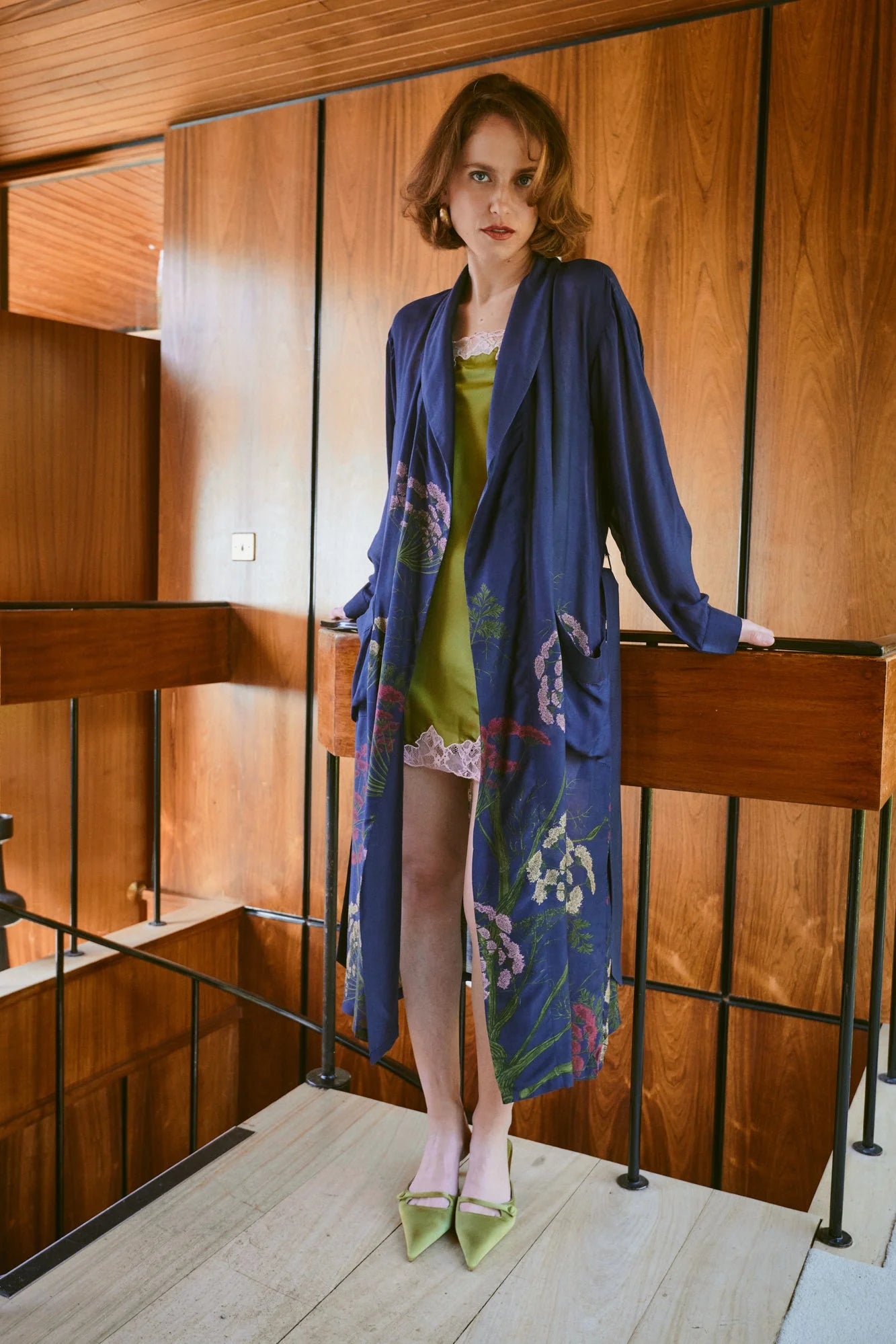 navy dressing gown with vibrant parsley seed flowers all over from one hundred stars model shot