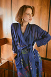 navy dressing gown with vibrant parsley seed flowers all over from one hundred stars model shot