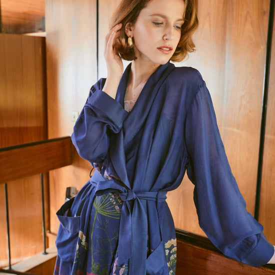 navy dressing gown with vibrant parsley seed flowers all over from one hundred stars model shot