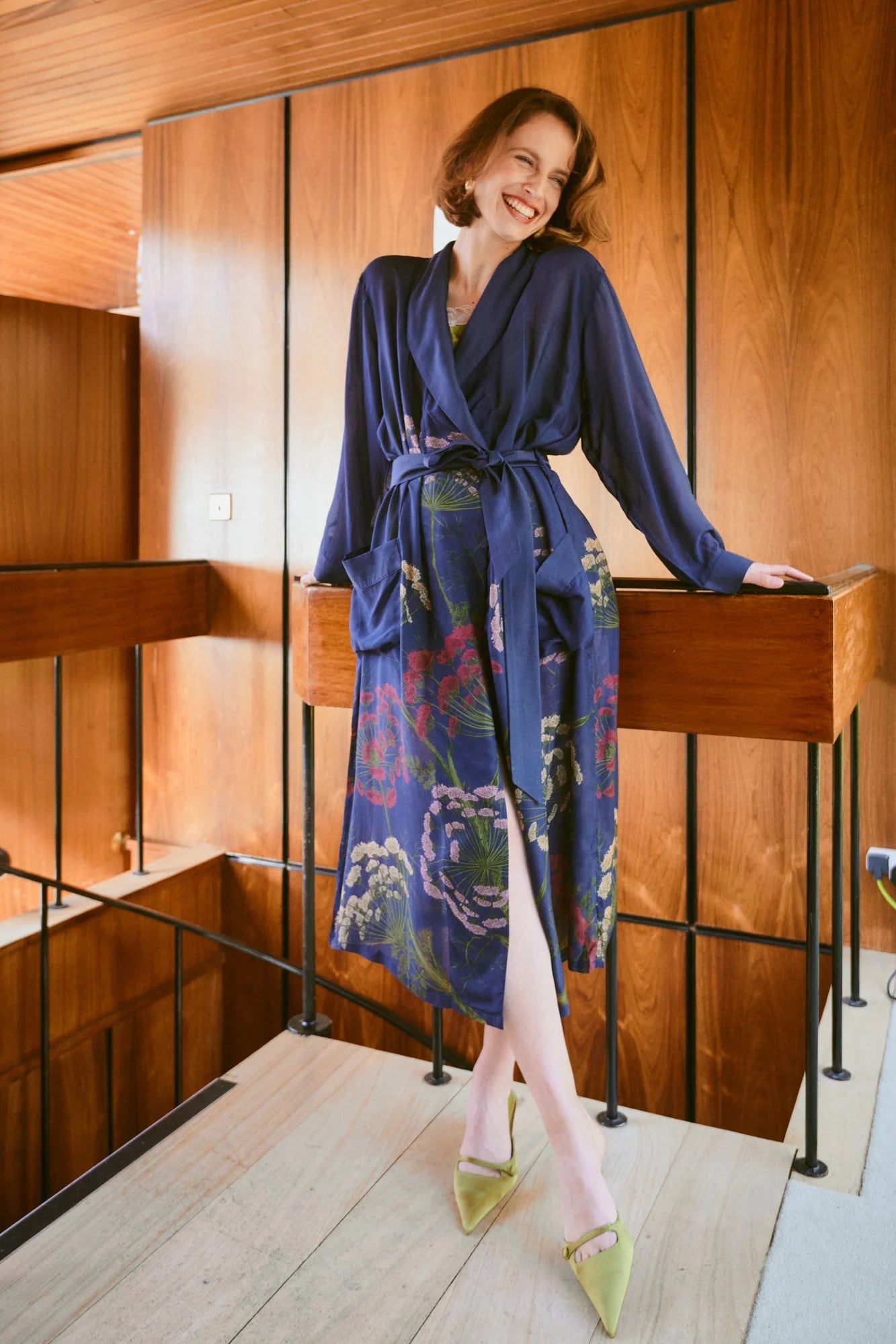 navy dressing gown with vibrant parsley seed flowers all over from one hundred stars model shot