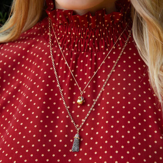 Gold pear pendant necklace on a dainty gold chain with pave diamond leaf