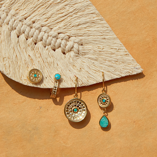 flat lay of some gold and blue earrings