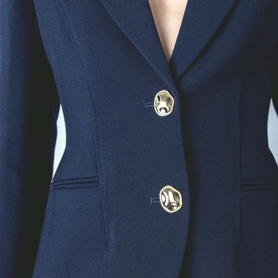 navy structured blazer with 2 gold hammered buttons close up