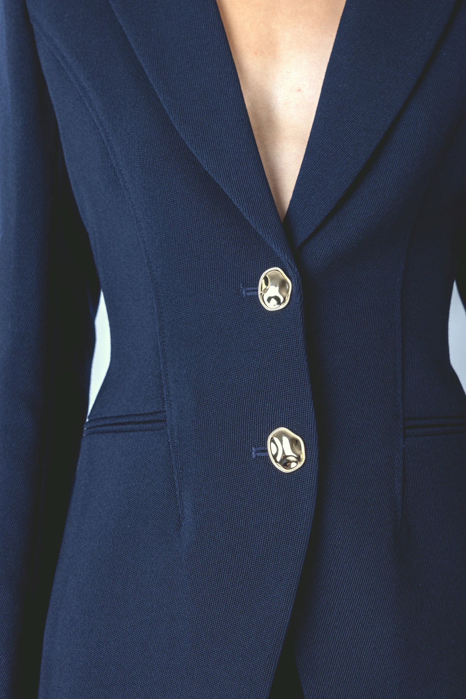 navy structured blazer with 2 gold hammered buttons close up