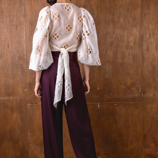 v neck sheer white blouse with tie at the front and blouson sleeves rear view