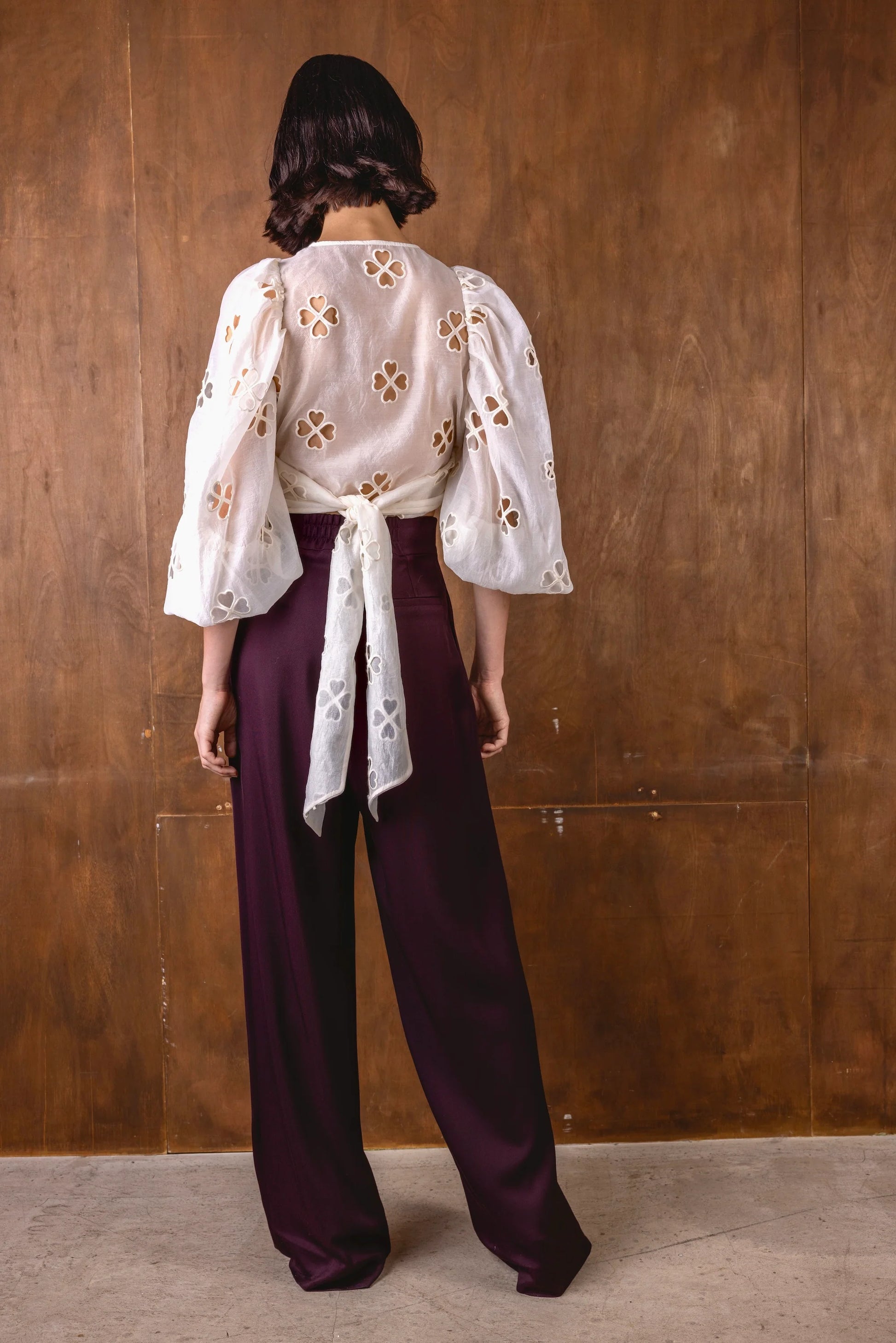 v neck sheer white blouse with tie at the front and blouson sleeves rear view