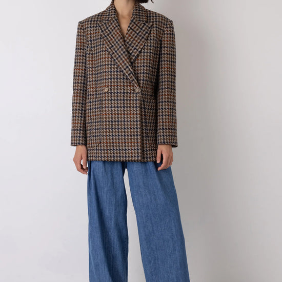 Brown check blazer styled with blue jeans