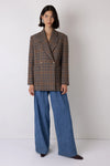Brown check blazer styled with blue jeans