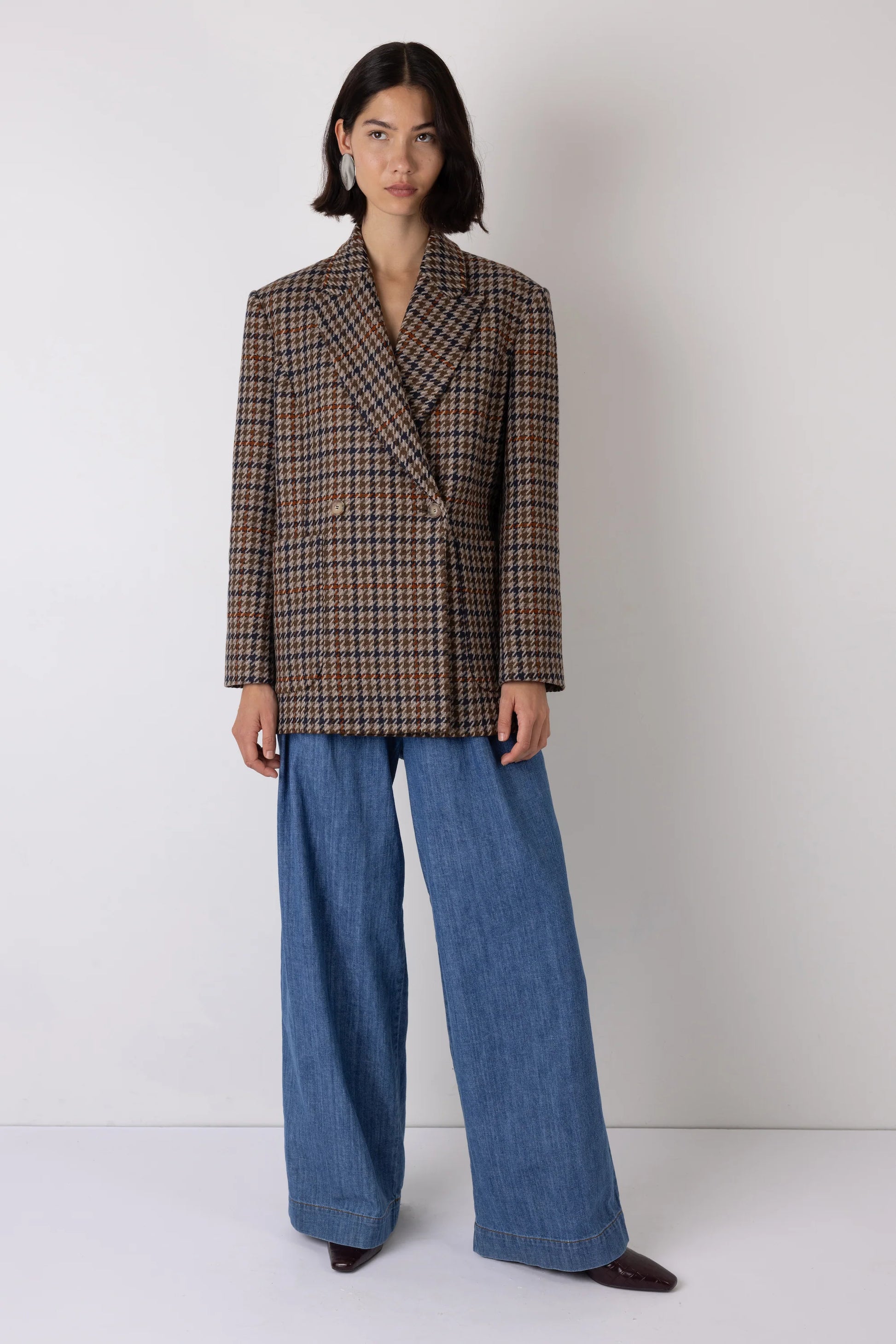 Brown check blazer styled with blue jeans
