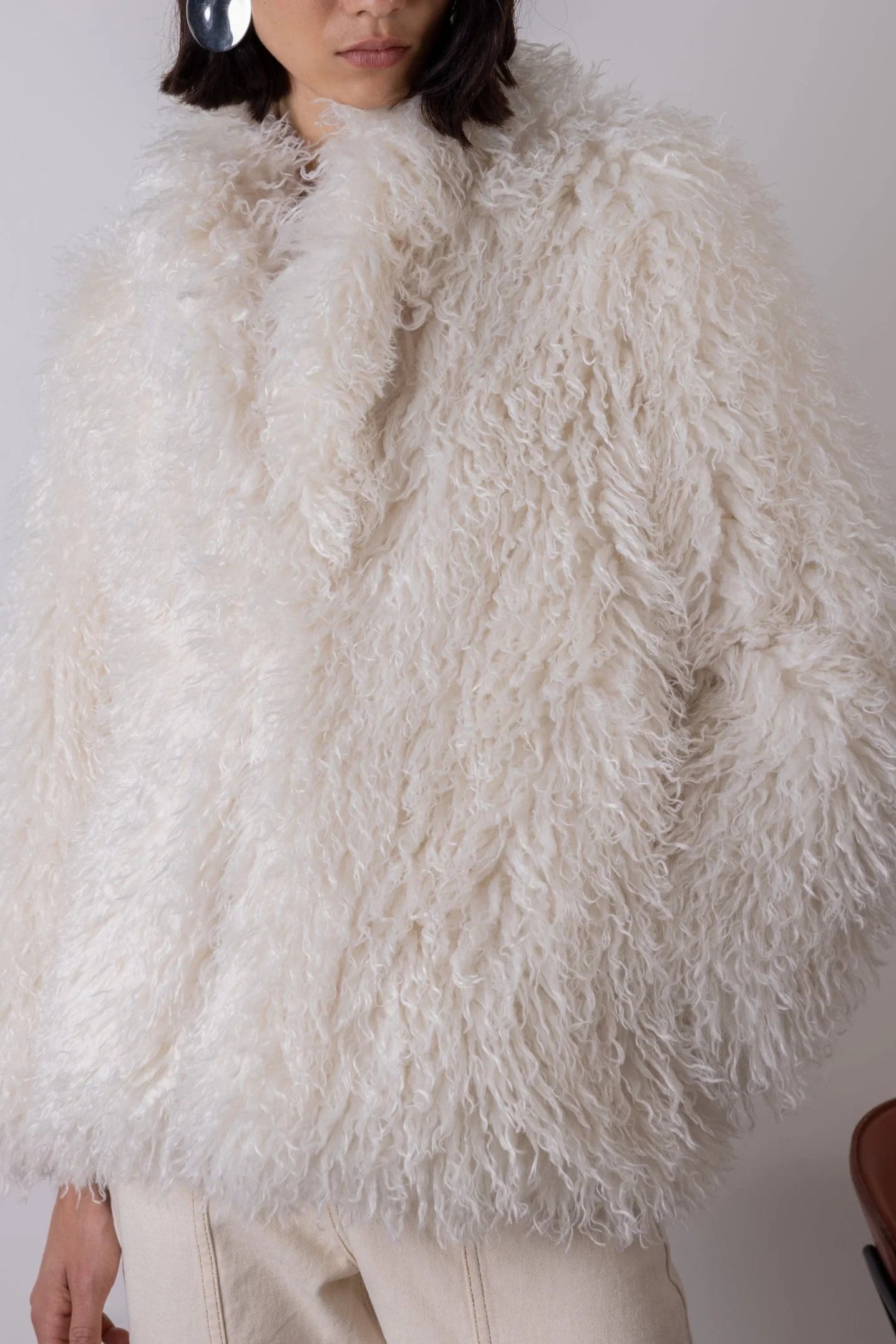 Cream shaggy faux fur jacket close up