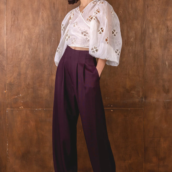 burgundy wide leg trousers worn with white wrap shirt