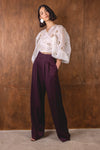 burgundy wide leg trousers worn with white wrap shirt