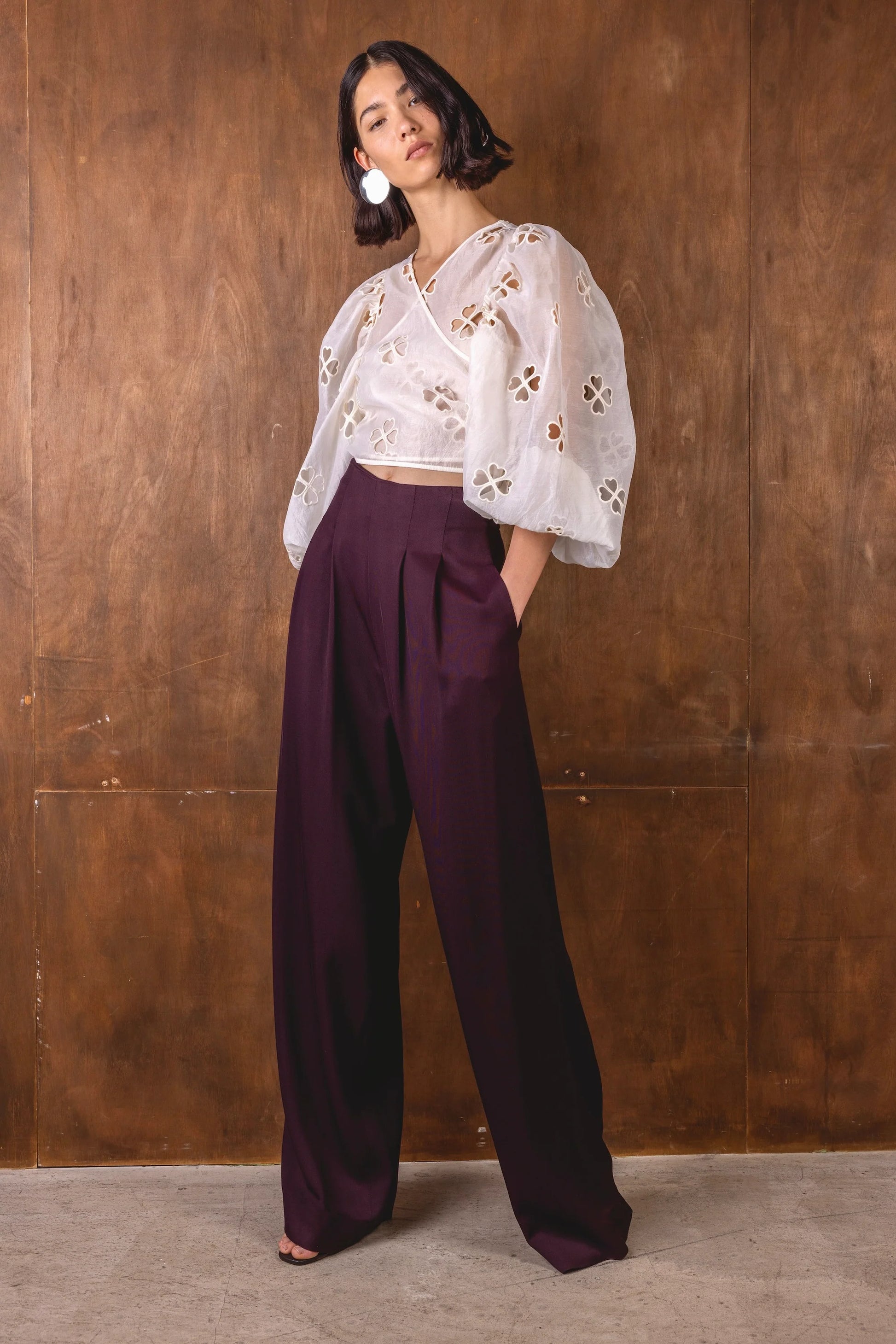 burgundy wide leg trousers worn with white wrap shirt