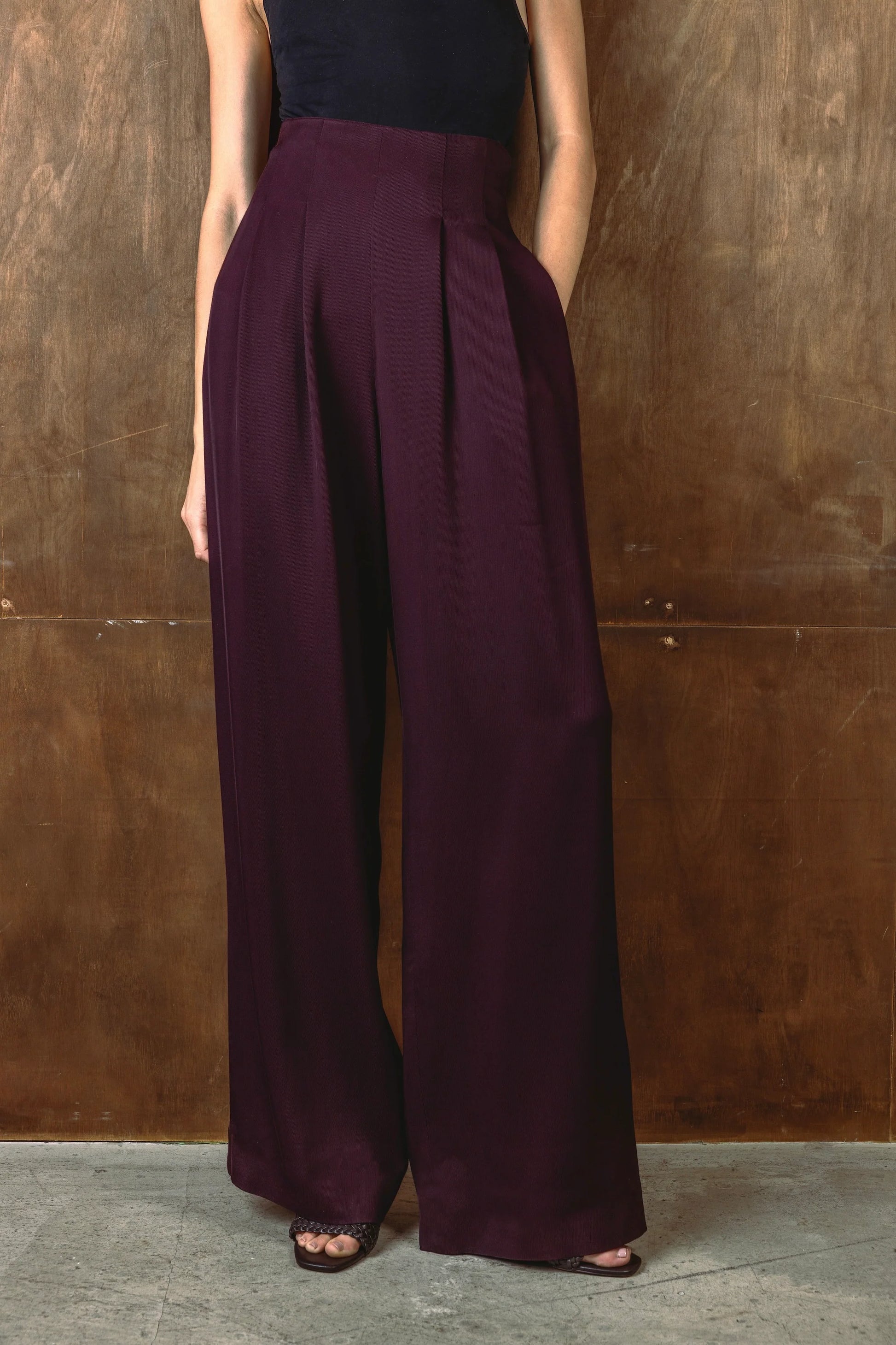 Close up of burgundy wide leg trousers