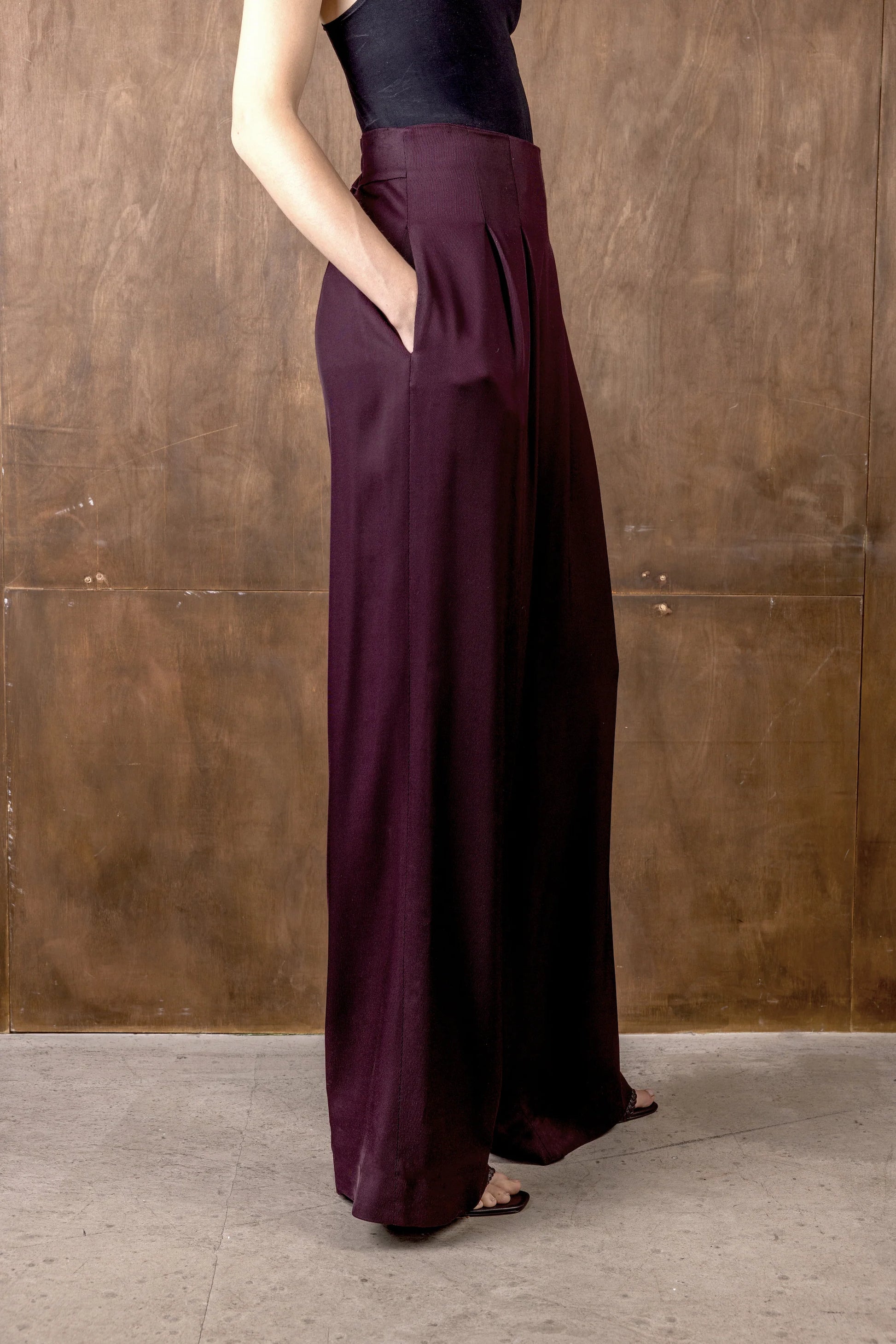 Side view of burgundy wide leg trousers