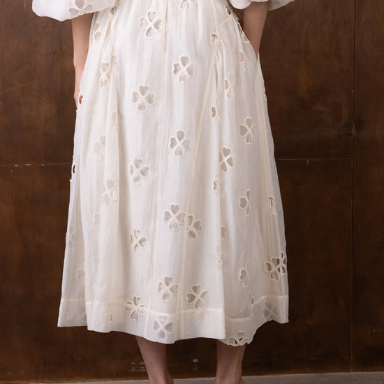 Rear view of white semi sheer skirt with cut out detail