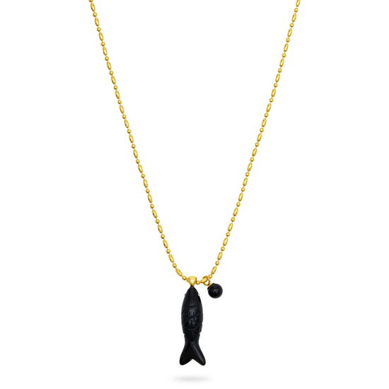 Gold necklace with a black fish pendant on a white background from talis chains