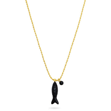 Gold necklace with a black fish pendant on a white background from talis chains