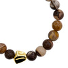 Beaded bracelet with a gold nugget on a white background close up from talis chains