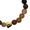 Beaded bracelet with a gold and black clasp on a white background close up from Talis Chain