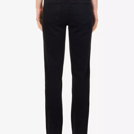 Rear view of a model wearing black straight-leg jeans against a plain white background.