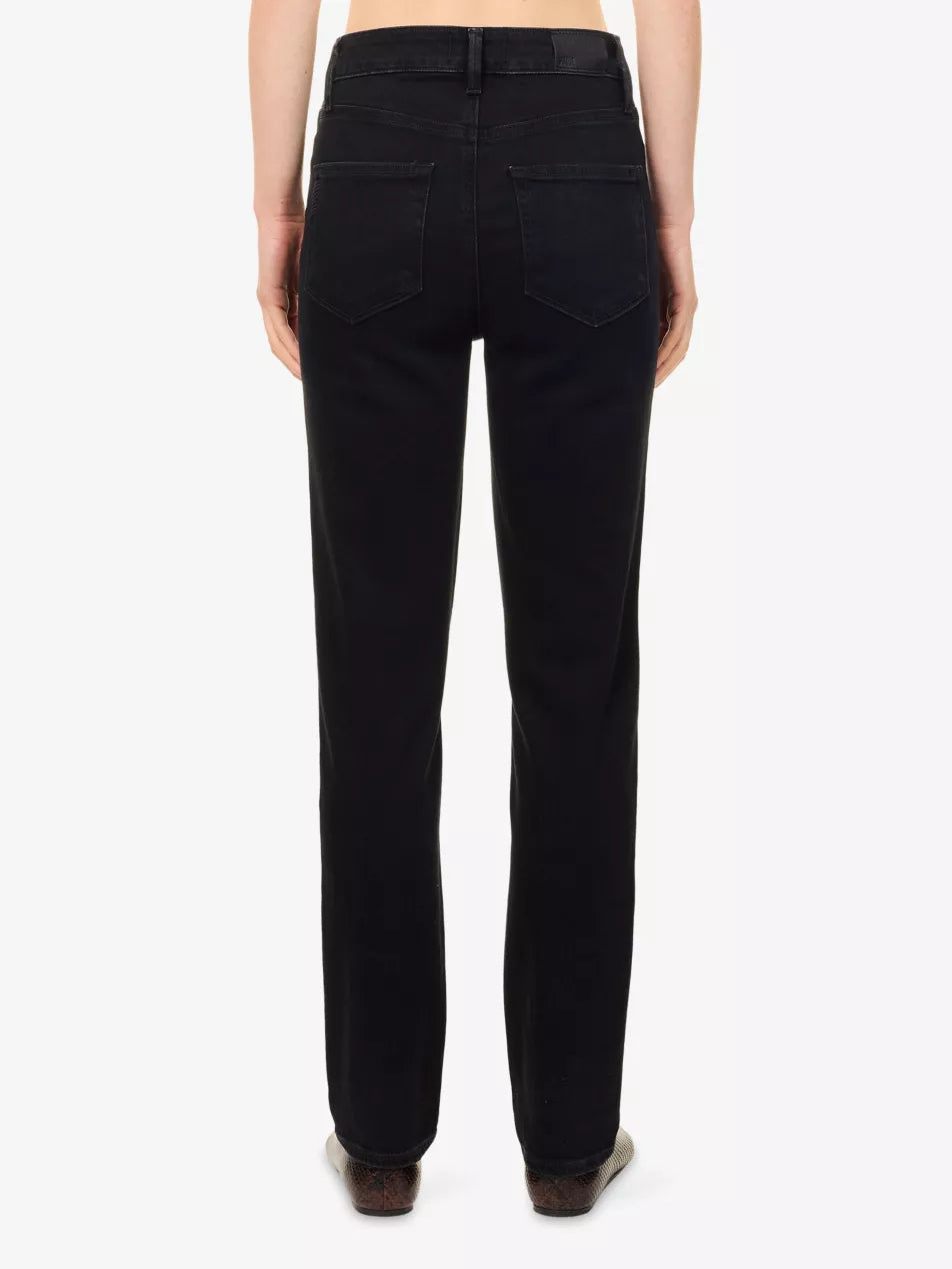 Rear view of a model wearing black straight-leg jeans against a plain white background.