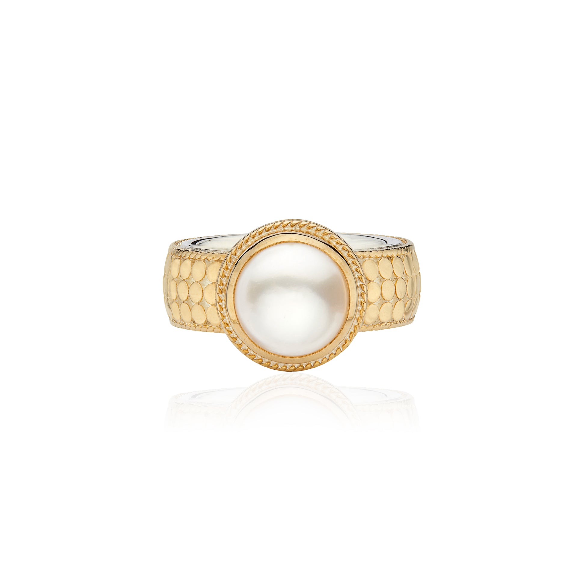 gold dotted ring with pearl in the centre