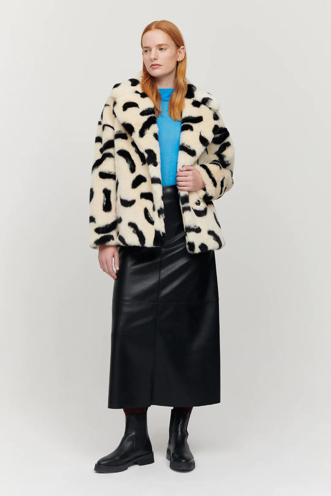 Ecru boxy faux-fur short jacket with V neckline and notch lapel / collar with side seam pockets and random black paintbrush markings