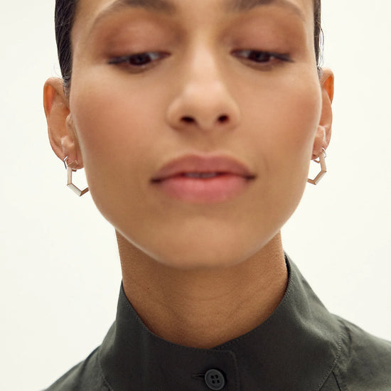 large silver hexagon shaped hoop earrings from claudia bradby model shot