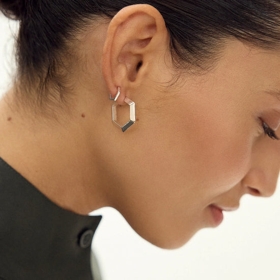 large silver hexagon shaped hoop earrings from claudia bradby model shot