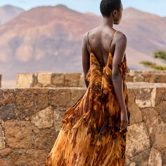 Rear view of tiered tie die dress with spaghetti straps