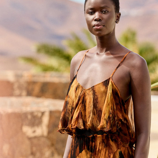 Close up of upper  body dress with tiers and spaghetti straps