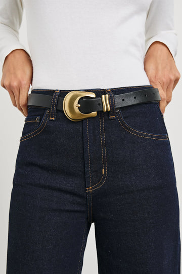 black leather belt with gold rodeo style buckle