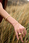 Rachel Jackson gold bird bracelet on a wrist
