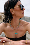 Woman wearing gold Rachel Jackson earrings with a blurred background