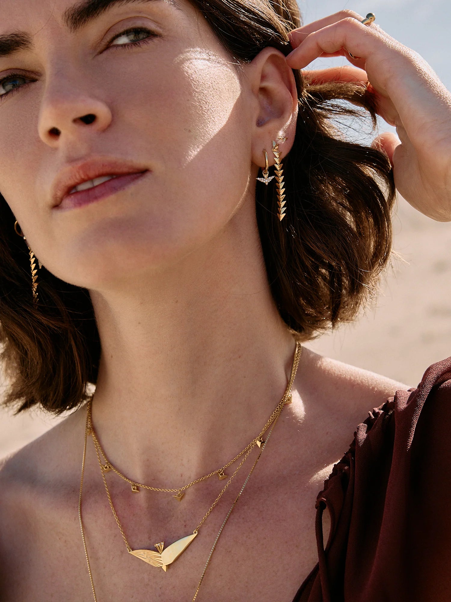 Woman wearing gold drop rachel jackson earrings