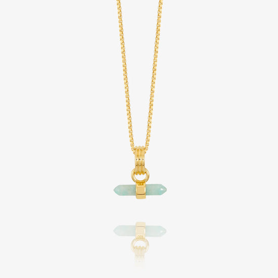 Gold necklace with a green pendant on a white background