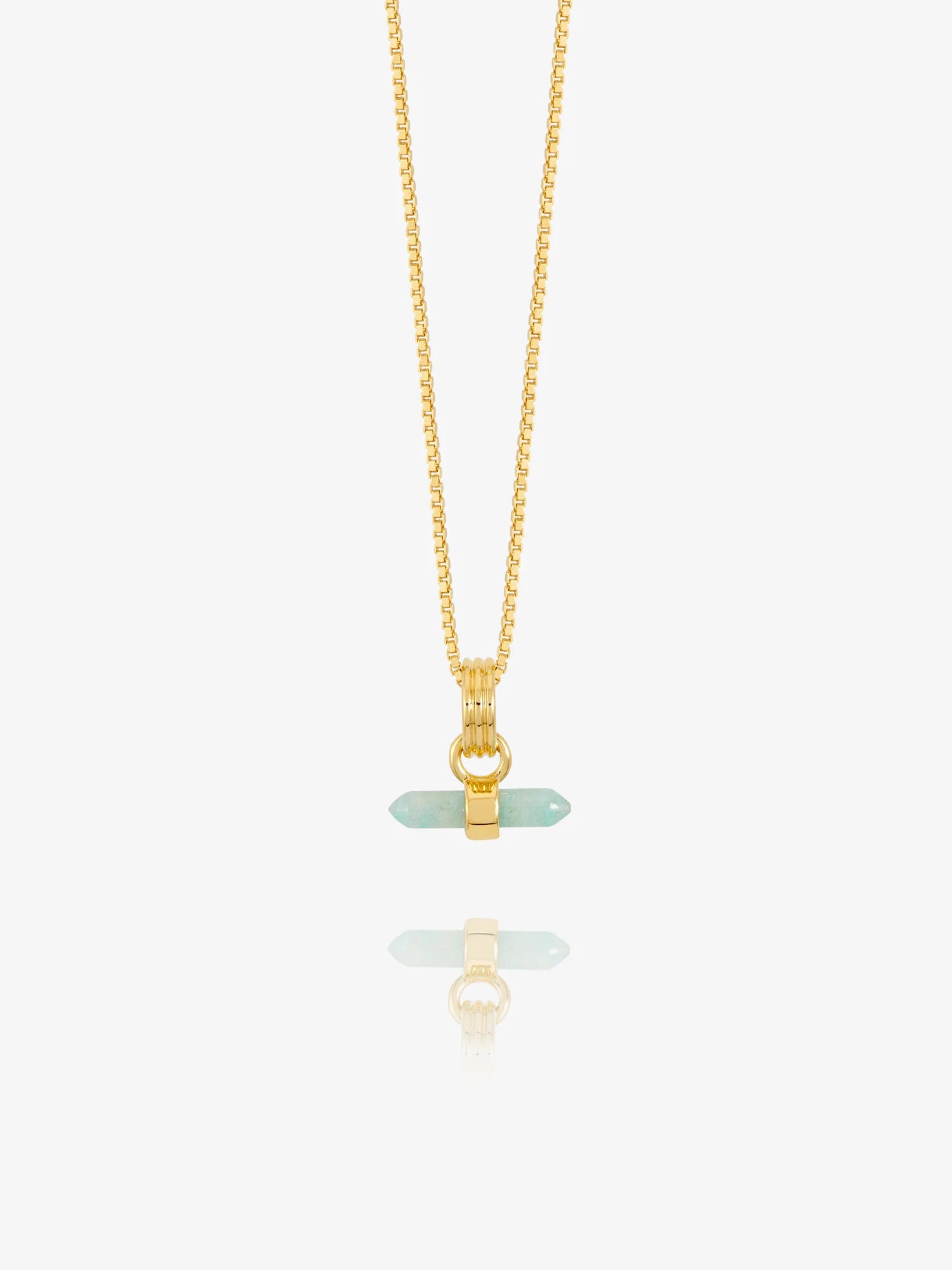 Gold necklace with a green pendant on a white background