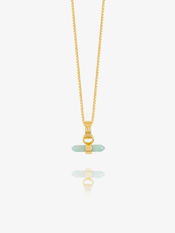 Gold necklace with a green pendant on a white background