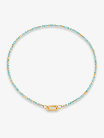 Necklace with blue beads and gold clasp on a white background